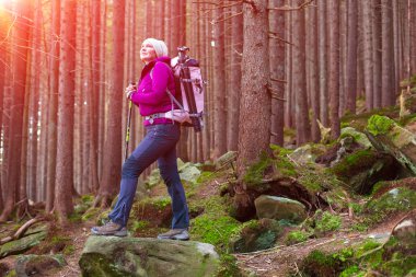 Smiling Female Hiker Staying in Deep Old Forest