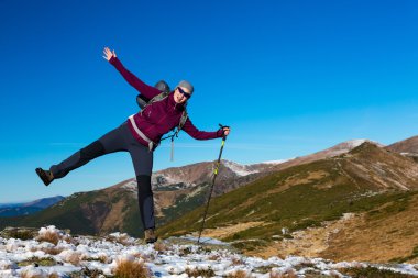 Female Hiker staying unstable on one leg falling on side in Mountains View
