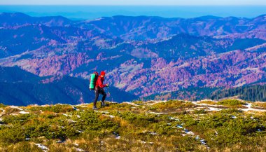 Hiker walking on Trail with Backpack Mountains View