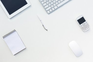 White Office Desk Table with Computer Keyboard  and Other Gadgets and Stationery