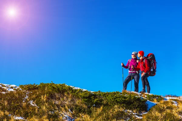 Two Travelers staying on grassy mountain ridge and enjoying Nature — Stok fotoğraf