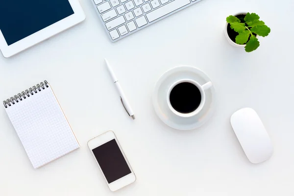 Top View of White Office Desk with Modern Electronics Stationery and Flower