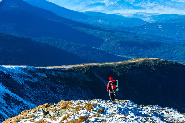 Caminhante andando na encosta da neve Montanhas empilhadas em longe — Fotografia de Stock