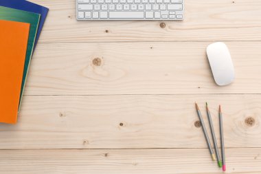 Working Place on light Wooden Desk with Stationery and Electronics