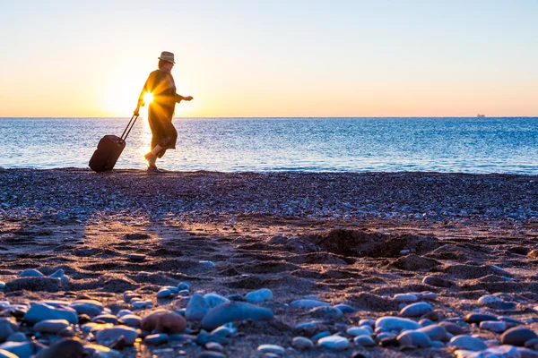 Person traveling Woman walking on Ocean Beach at Sunrise