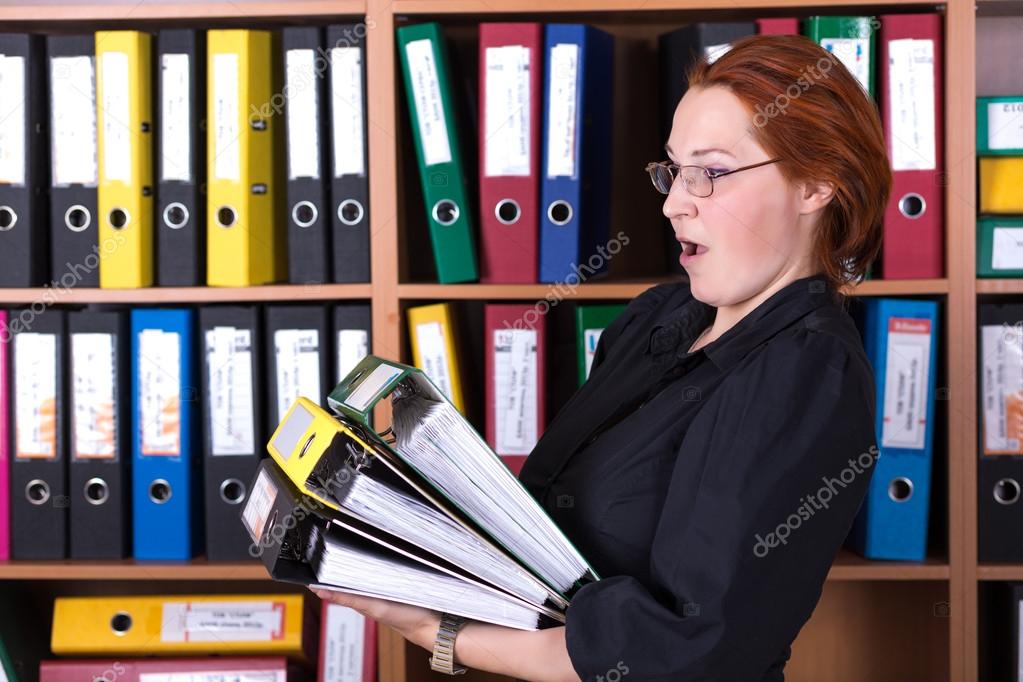 Business Lady holding large Stack of Office Folders
