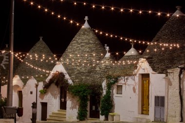 Alberobello trullo at night decorated with hundreds of little li
