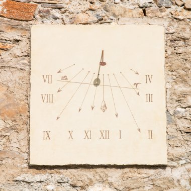vertical sundial made of  carved stone's slab  and  iron rod clipart