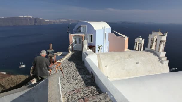 Pintura artística en la ciudad de Oia Island Santorini, Grecia — Vídeos de Stock