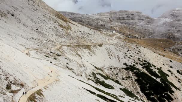 Randonneurs marchant le long d'une montagne enneigée — Video