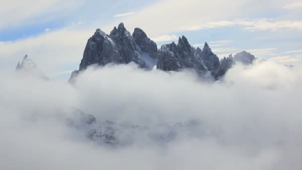 Belle vue de nuages passant sous un pic rocheux — Video