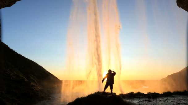 Seljalandsfoss Island západ slunce vodopád skalní tvář útes turistika — Stock video