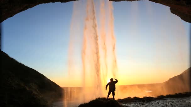 Iceland Seljalandsfoss sunset Waterfall mist rock face cliff hiking — Stock Video