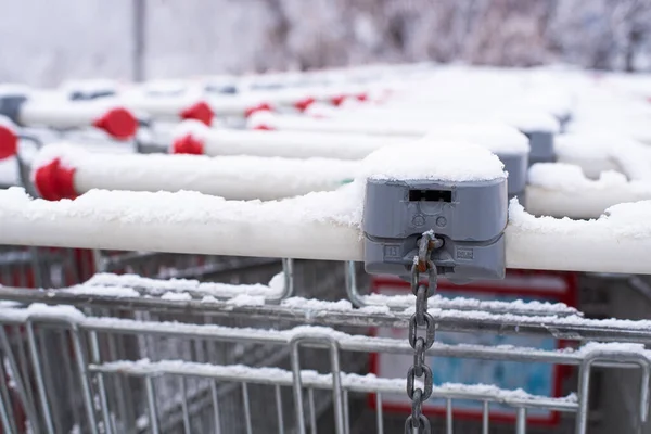 An abandoned cart in the snow. Theyre behind the fence