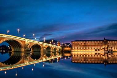 The Pont Neuf Bridge in Toulouse, France in the early evening clipart