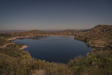 Looking down on Lake Poway early one morning from one of the nearby hiking trails near San Diego, California clipart
