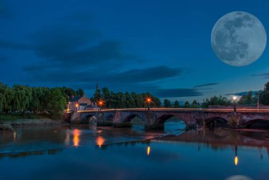 Full moon over the Old Dee Bridge in Chester, UK clipart