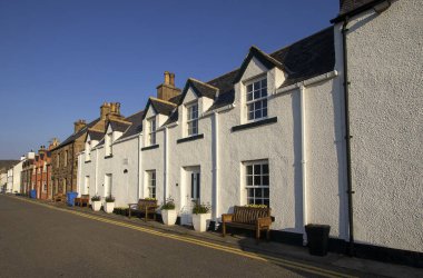 A row of houses along the waterfront in Ullapool in the Scottish Highlands, UK clipart
