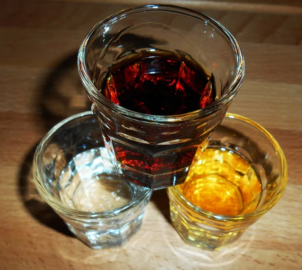 Shot glasses on a wooden surface — Stock Photo, Image