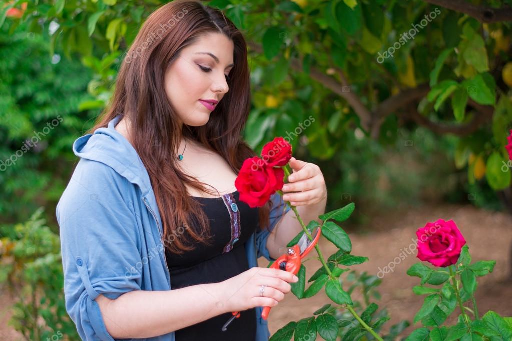 Girl cutting a rose — Stock Photo © ValEs1989 75108757