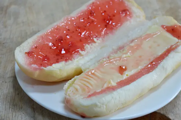 Bread filling strawberry jam and cheese on dish — Stock Photo, Image