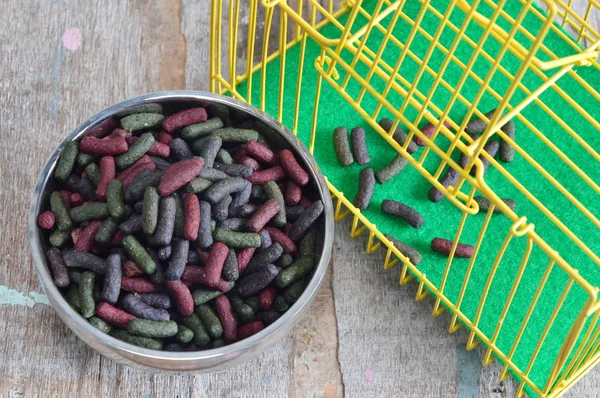 Rabbit food in stainless bowl and cage — Stock Photo, Image