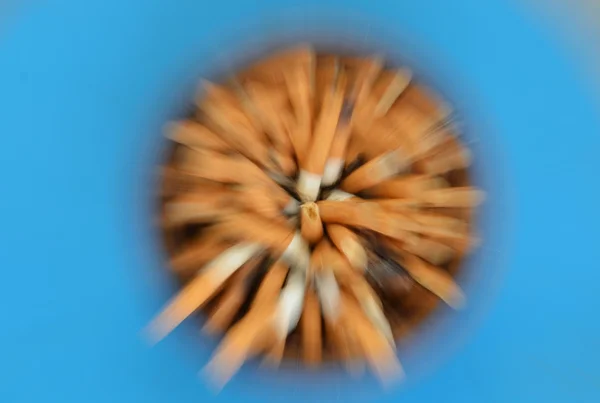 Blurry zoom technique of cigarette filter in ceramic ash — Stock Photo, Image