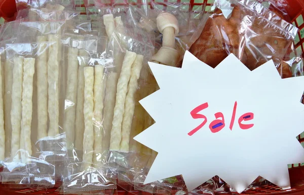 dog snack in plastic bag packing on basket for sale in pet shop