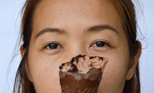 chocolate ice cream in front of woman eye