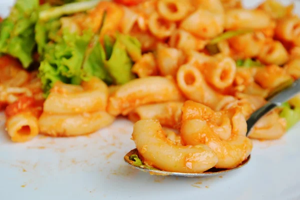 Stir fried macaroni with egg and ketchup on spoon — Stock Photo, Image