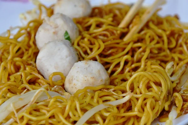 Fideos de huevo con aderezo de bola de cerdo salsa de soja dulce negro en el plato — Foto de Stock