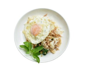 spicy fried chop pork with basil leaf and chili topping egg on rice in dish