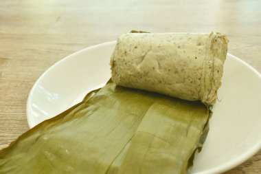 Vietnam usulü domuz püresi ve mantar sosisi. Yeşil muz yaprağıyla sarılıp paketlenmiş. 