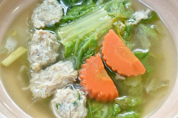 boiled cabbage and carrot with chop pork stuffed glass noodles soup on bowl