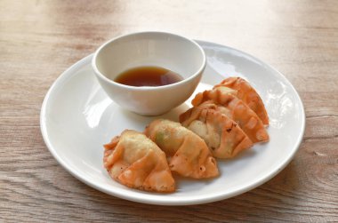 Kızarmış Gyoza ya da Japon hamur tatlısı doldurulmuş domuz püresi tabakta Shoyu sosu.
