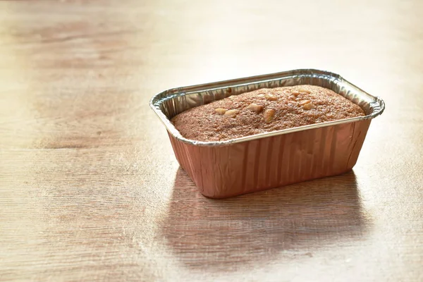 butter banana cake topping peanut in aluminum tray on table