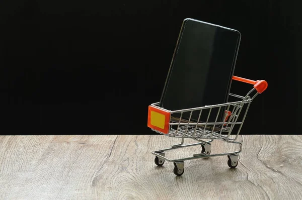 Small Shopping Cart Carry Mobile Phone Black Background — Foto Stock