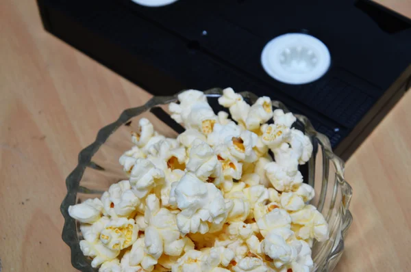 Video recorder cassette and pop corn — Stock Photo, Image