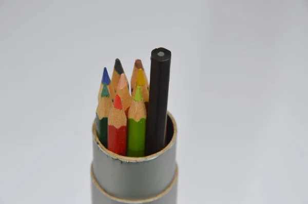 Black pencil and color pencil in the box — Stock Photo, Image