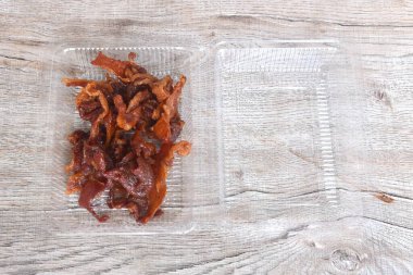 şeffaf plastik ambalaj kutusunda soya sosunda mayalanan tuzlu ve kuru domuz eti.