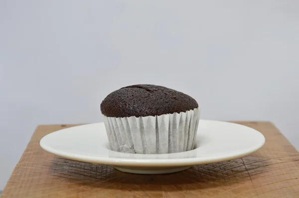Chocolate muffin on wooden board — Stock Photo, Image