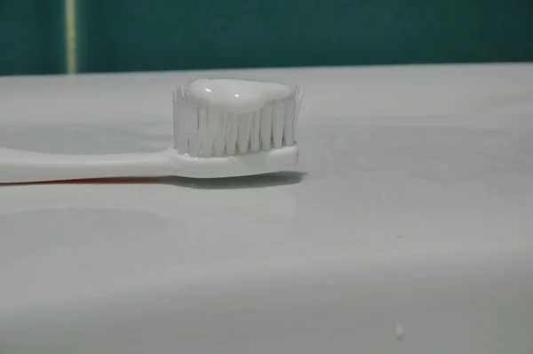 Toothpaste on white toothbrush — Stock Photo, Image