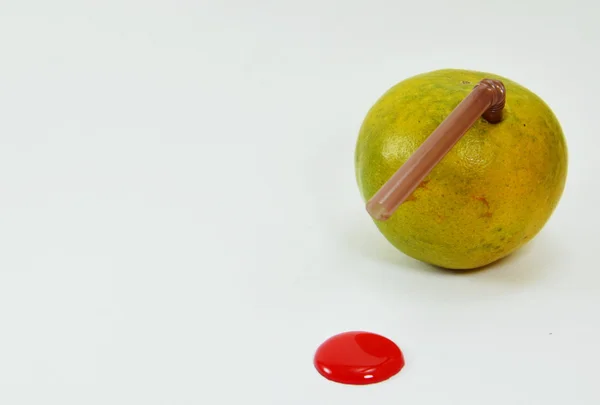 Straw stab in orange with liquid red dot — Stock Photo, Image