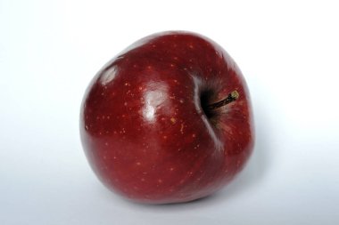 Beyaz üzerine izole edilmiş parlak koyu kırmızı bir elma.