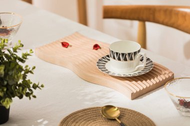 Wooden cutting board on kitchen table for product display