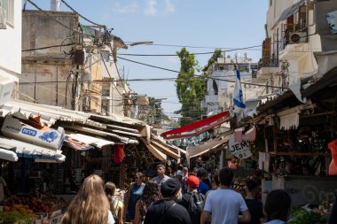 Tel Aviv, İsrail - 16 Ağustos 2021: Güney Tel Aviv 'deki Hakarmel pazarı popüler ve kalabalık bir alışveriş merkezidir. Ancak ziyaretçilerin sadece küçük bir kısmı koruyucu maske takıyor. Tel Aviv, İsrail - 16 Ağustos 2021: Güney Tel Aviv 'deki Hakarmel pazarı,