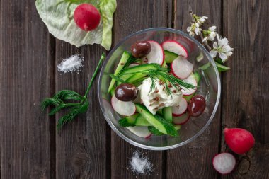 Tahta zemin üzerinde taze turp ve salatalık salatası manzarası