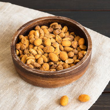 Spicy peanuts in a wooden bowl