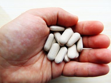 Bir elinde ilaç hapları