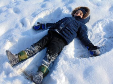 a little boy is playing in the snow